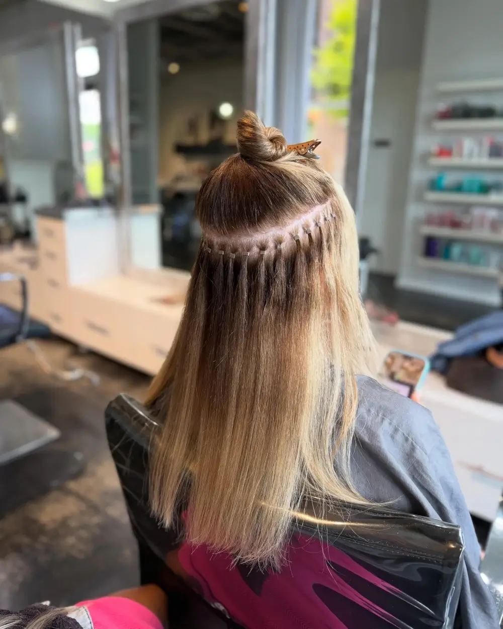 Hair extension bead placement during an extension installation at Michele Coulter Salon in Milton GA